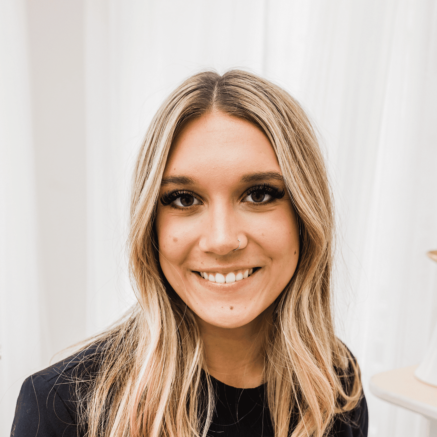 Portrait of Belle, a professional stylist at Spa 309 Salon & Boutique, showcasing their expertise and style.